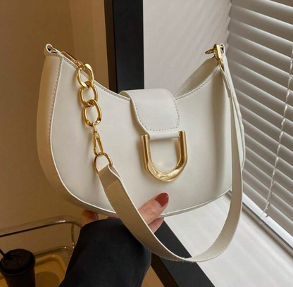 Compact and chic white handbag with gold hardware