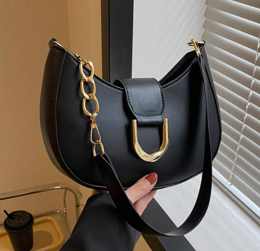 Stylish handbag with gold chain detailing